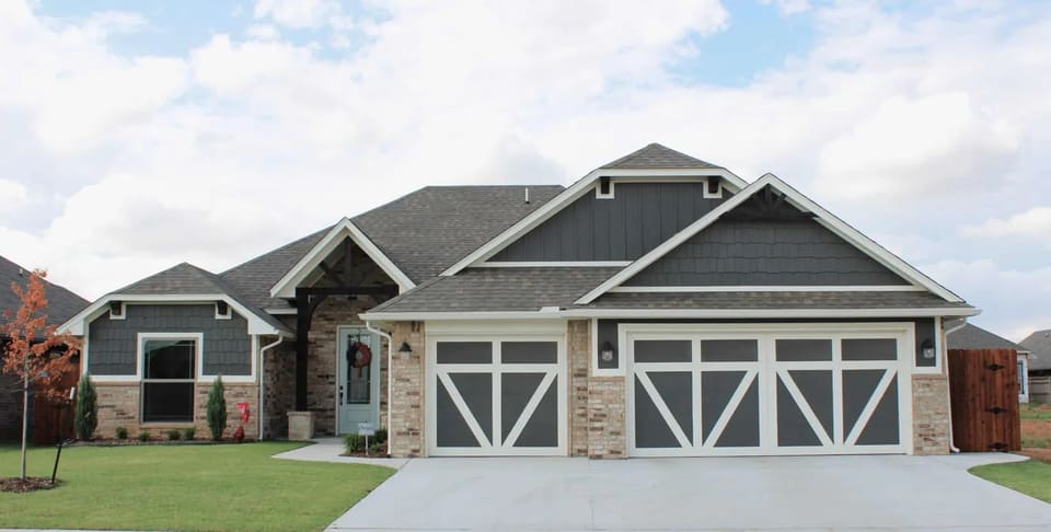 Craftsman-style home exterior painted gray with crisp white trim
