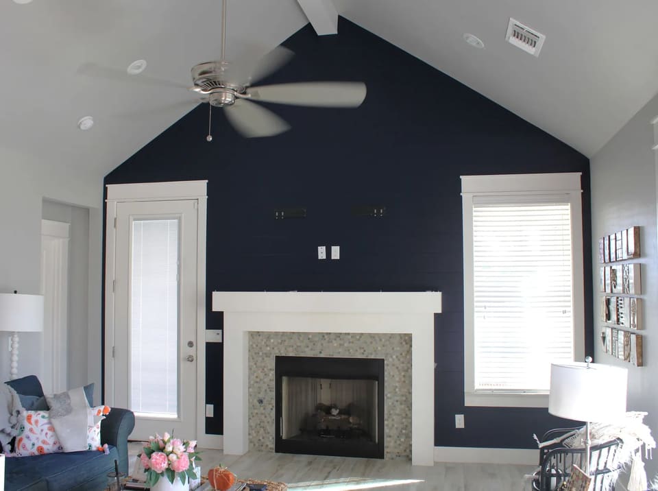 Bethany, OK living room with a navy shiplap accent wall and white mantel