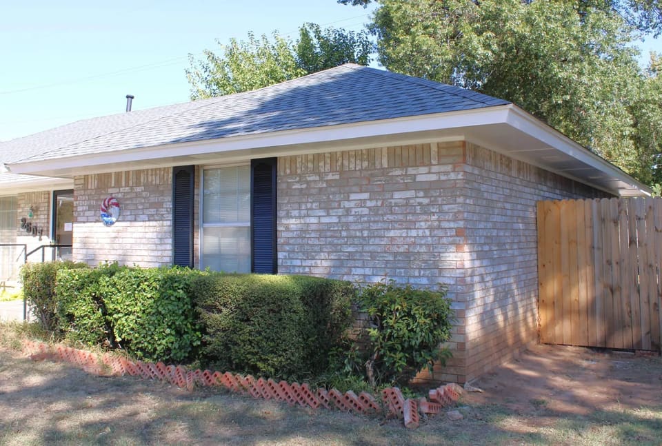 Brick ranch home in Bethany, OK with freshly painted black shutters