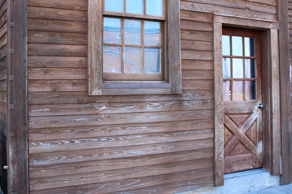 siding stain before old faded stain on the barn siding