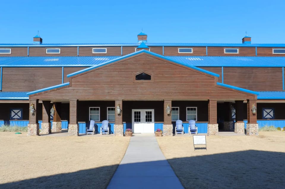 The Express Clydesdale barns in Yukon, OK after cedar siding restoration and staining by Hometown Painting