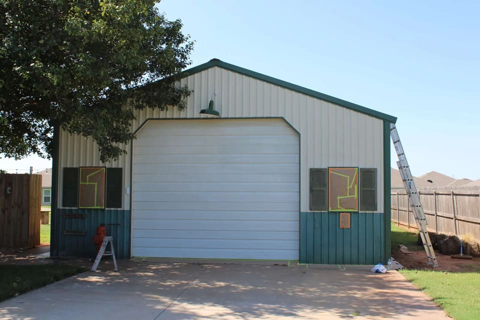 a metal shop building in Oklahoma City with faded, chalky metal siding in need of a paint job.