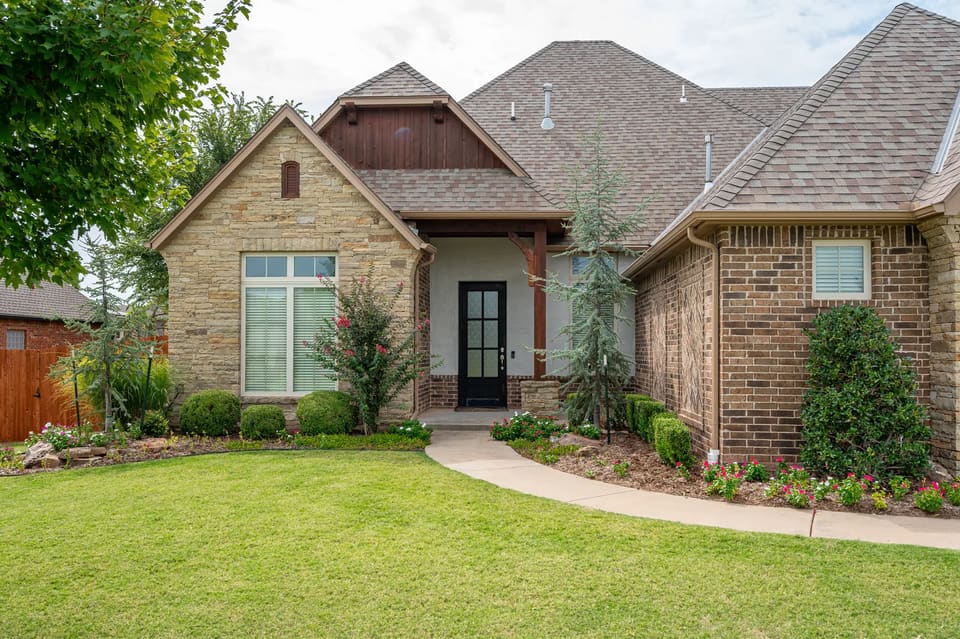 Exterior repaint of a stone and brick home in the OKC metro