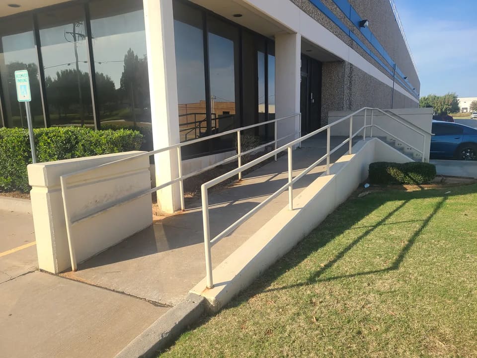 A freshly repainted commercial office building with an accessible entrance ramp in the OKC metro