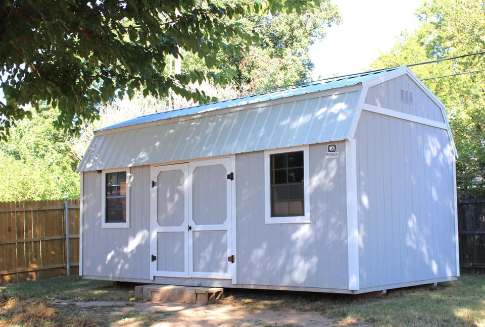 Backyard shed in Bethany, OK repaired and painted gray with white trim