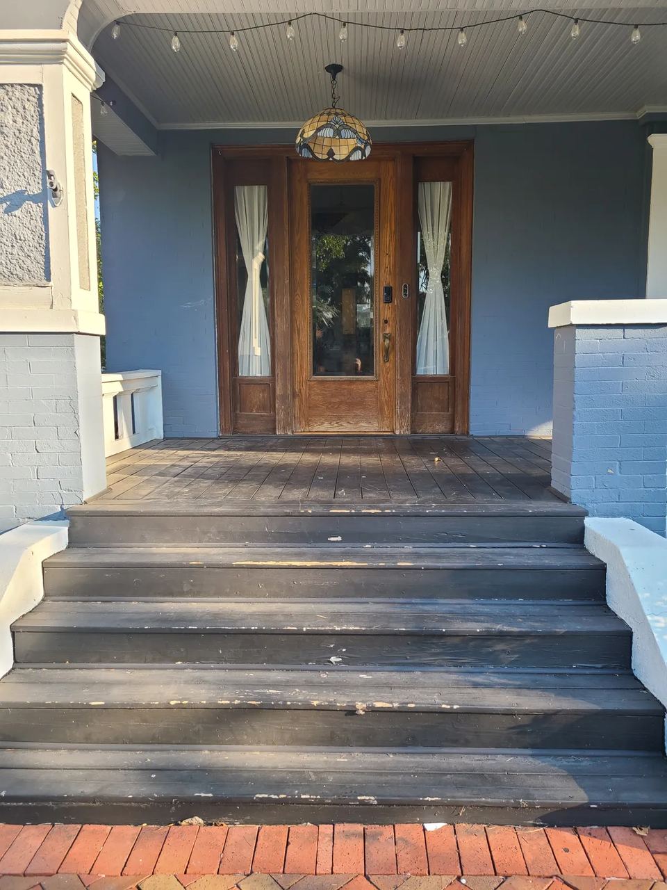 Before: weathered, peeling porch decking and a tired entry on a Mesta Park home