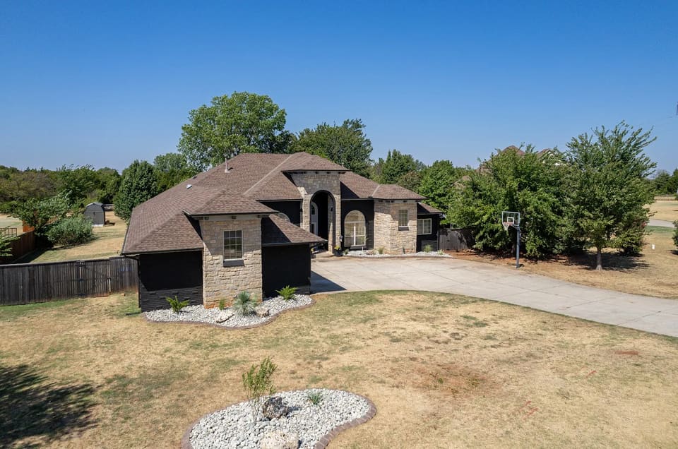 Aerial view of the Edmond home with Celtic Stone painted brick and natural stone accents on a large corner lot