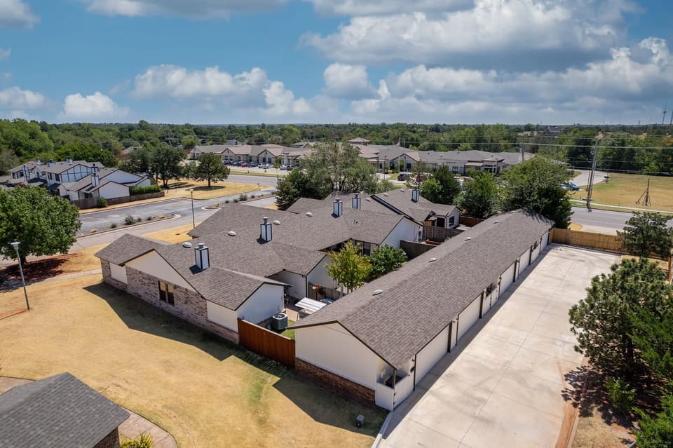 Aerial view of The Crossing townhome community in Edmond, OK showing multiple freshly repainted buildings